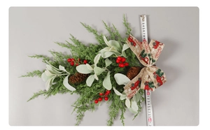 Detail of Christmas wall hanging with pine cones, berries, and red truck ribbon 40cm