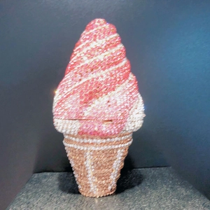 Close-up of pink and white ice cream clutch bag featuring dense rhinestone embellishments