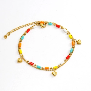 Detail view of double-layer gold chain with colorful rectangle beads and heart pendants