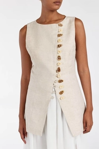 Detail of linen sleeveless top featuring asymmetric button closure and natural texture