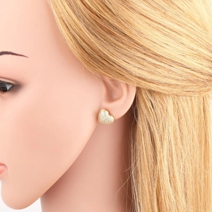 Golden heart stud earrings with cubic zirconia inlay on a model mannequin