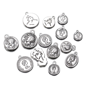 Detailed top view of assorted vintage silver coin pendants for DIY jewelry making accessories