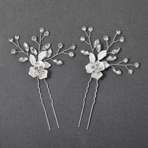 Elegant pair of silver floral bridal hair clips with crystals and leaf-shaped details