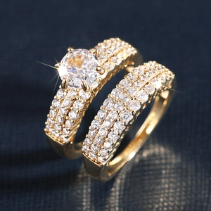 Macro shot of a gold engagement ring set with large zircon and matching pavé eternity band