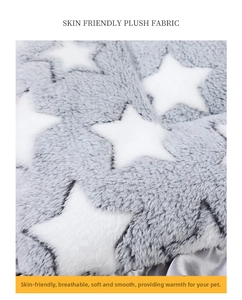 Close-up of thick plush grey pet blanket with white star pattern for cats and dogs