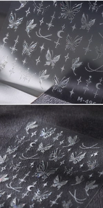Macro shot of silver laser butterfly nail stickers with star and moon patterns M-496