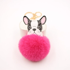 Detailed view of plush rose red faux fur pompom and leather french bulldog bag charm