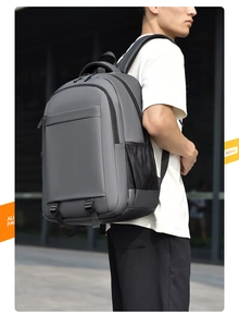 Detail view of large capacity dark grey backpack with mesh side pocket and adjustable straps