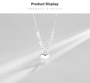 Detailed close-up of S925 sterling silver heart necklace with beaded chain and soft shadows