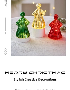 Close-up of glowing angel Christmas decor with textured stripes in green, gold and red