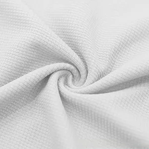 Detailed macro view of pure white waffle knit fabric texture showing the woven square pattern