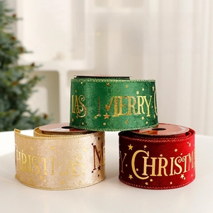 Velvet Christmas ribbons in red, green and gold with golden Merry Christmas letters