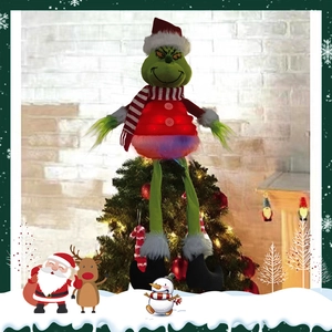 Detailed view of plush Grinch tree topper with glowing red vest on a Christmas tree