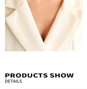 Detailed view of the notched lapel and fine woven texture of the white blazer