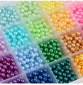 Close-up of a 28-grid organizer filled with 6mm colorful ABS round pearl beads for DIY crafts