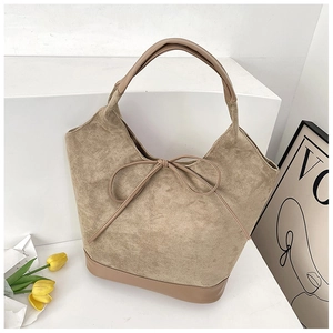 Detailed view of khaki suede tote bag with leather拼接 and knotted string decoration