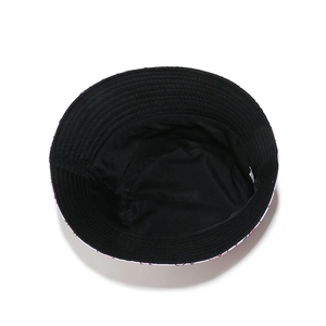 Detail view of pink and black reversible cotton sun hat with internal fabric label