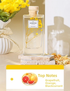 Detail view of WINKSTAR 8 fragrance oil bottle with yellow dried flowers and wooden cap