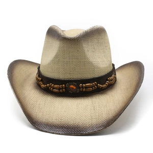 Detail of straw cowboy hat featuring burnt edges and wooden beads with amber stone