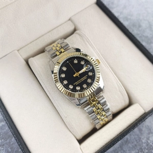 Two-tone steel watch with black dial, diamond markers, and date window in a beige gift box