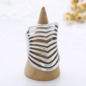 Fashion wide hollow wave line stainless steel ring for women on a wooden stand