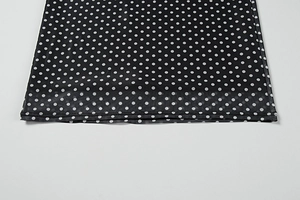 Detail shot of white polka dot mesh fabric with high-quality flat seam stitching edge