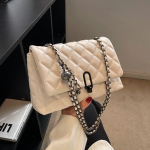 Modern white quilted shoulder bag with black chain strap and metal clasp detail