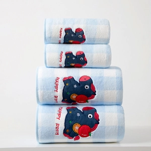 Close-up of soft coral fleece towels with blue plaid pattern and happy pony embroidery