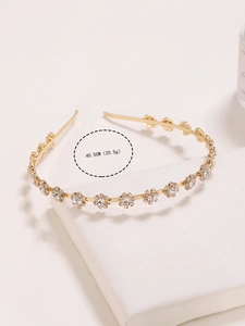 Detail of a thin gold headband with sparkling crystal sunflowers and size dimensions