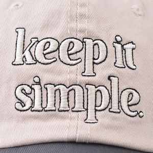 Detailed close-up of the vintage 'keep it simple' embroidery on a washed cotton baseball cap