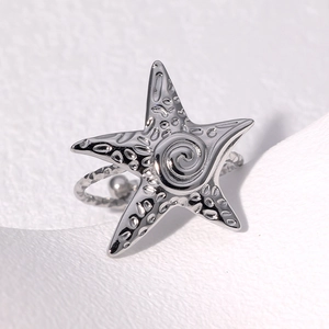Irregular starfish ring in silver stainless steel with hammered texture and spiral center
