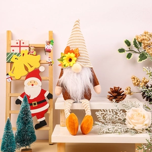 Harvest gnome plush with maple leaf hat and sunflower accents on white steps