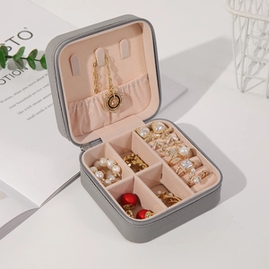 Detailed close-up of gray PU leather jewelry box featuring necklace hooks and ring slots