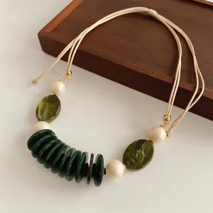 Vintage green resin disc and marble bead double-layer necklace on wooden tray
