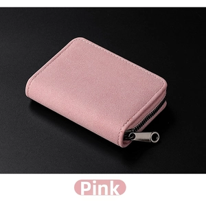 Close-up of a pink matte card holder with fine white stitching and a silver zipper puller