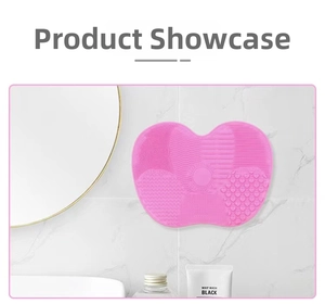 Detailed view of pink silicone heart makeup brush cleaning mat with suction cups