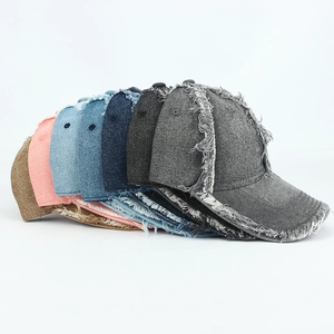 Selection of distressed denim baseball caps with frayed edges in multiple colors