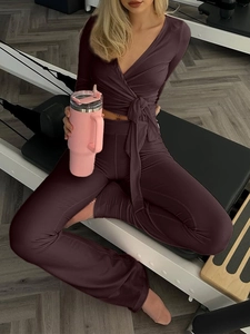 Ensemble de yoga violet foncé avec haut à manches longues col V et legging évasé