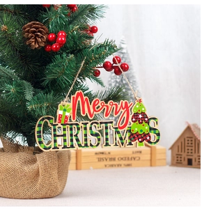Detail of wooden Merry Christmas hanging sign on a festive tree with berries and pinecones