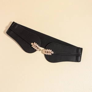 Close-up of vintage golden leaf buckle with detailed textures on black elastic belt