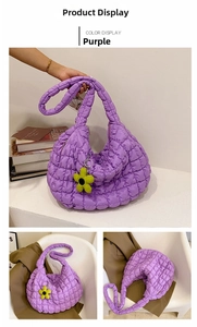 Detail of purple quilted cloud tote bag with yellow flower charm and square texture