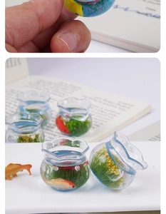 Close-up of miniature clear fishbowl pendant with tiny koi fish and green water plants