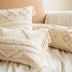 Bohemian style tufted beige pillow covers with geometric patterns and fringe for sofa
