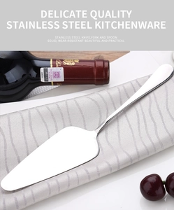 Detailed shot of stainless steel cake server with serrated edge in elegant dining setting