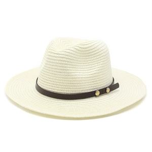 Detailed view of woven fedora hat texture with brown faux leather band and metal studs