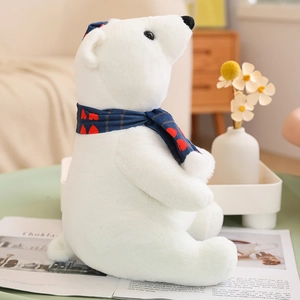 Christmas polar bear plush toy with blue heart scarf in a cozy home setting