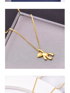 Close-up of 18k gold plated bear pendant necklace on a jewelry gift box display