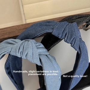 Close-up of knotted denim headbands set in dark blue, light blue and black denim fabric