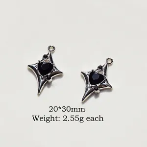Detail of silver alloy starburst heart pendant with black gemstone, size 20x30mm