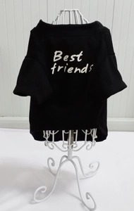 Close-up of black cotton pet T-shirt featuring white Best Friends text on a hanger